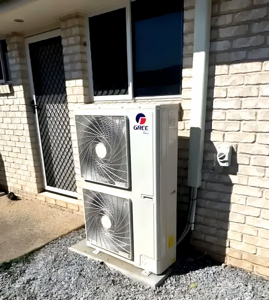 DSMQ technician servicing an air conditioning unit in Gladstone