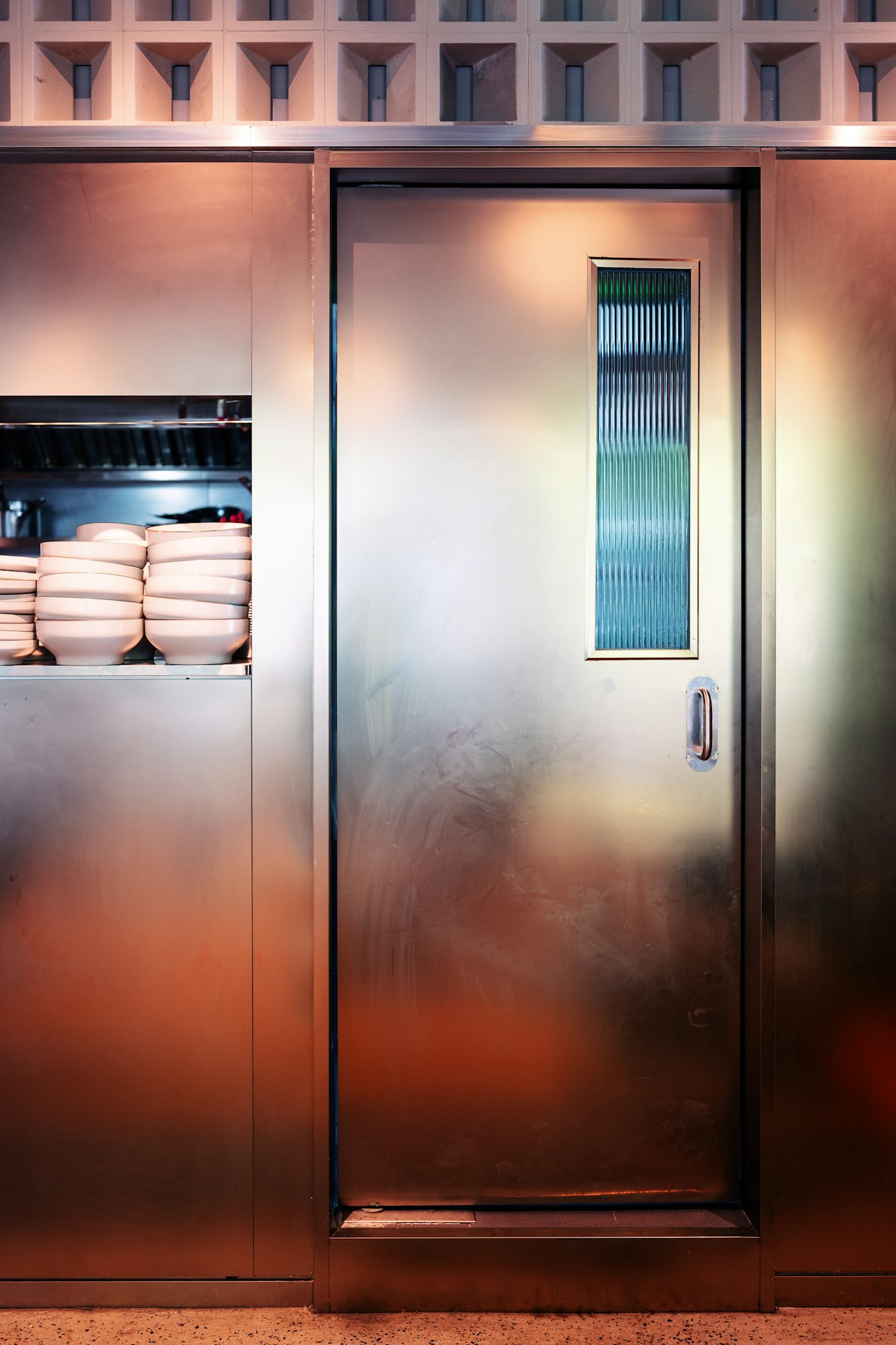 Stainless steel cool room door in a commercial kitchen